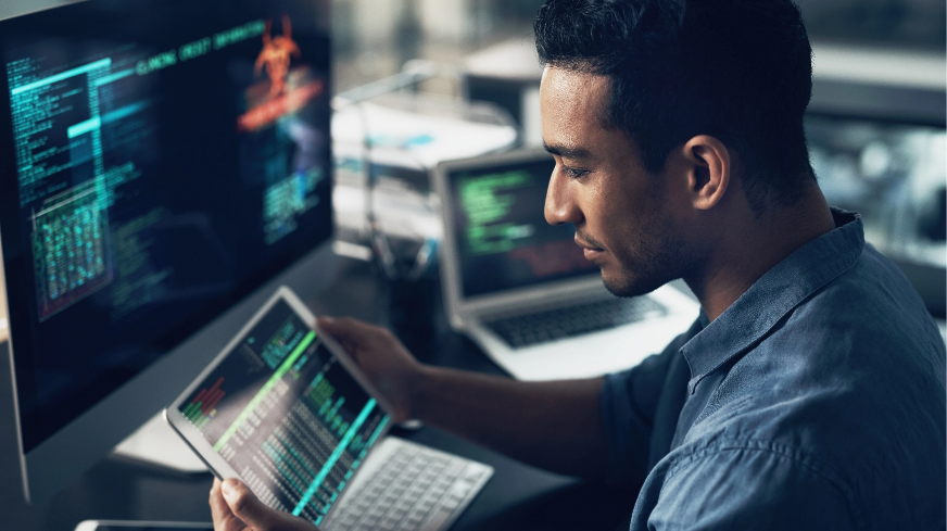 A software engineer views data on a tablet