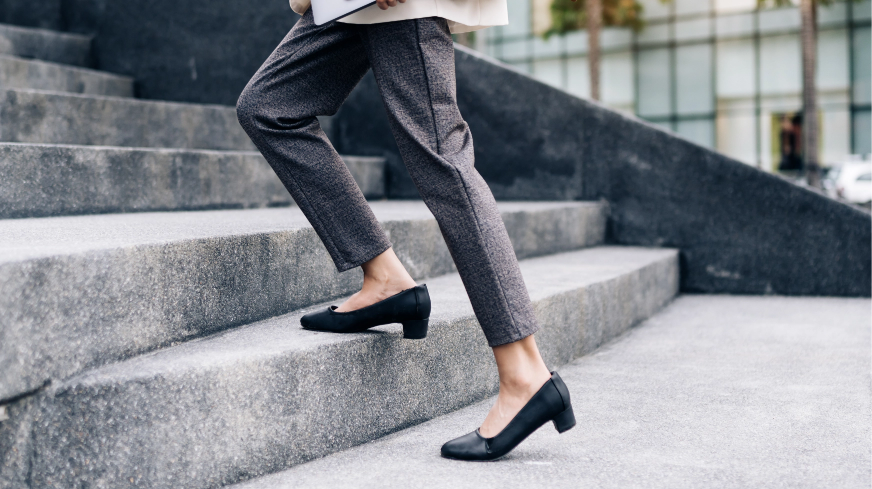 A business women ascends a flight of stairs