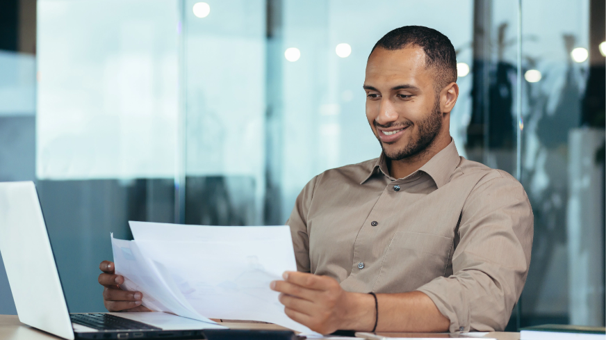 A Client smiles as they look at financial reports